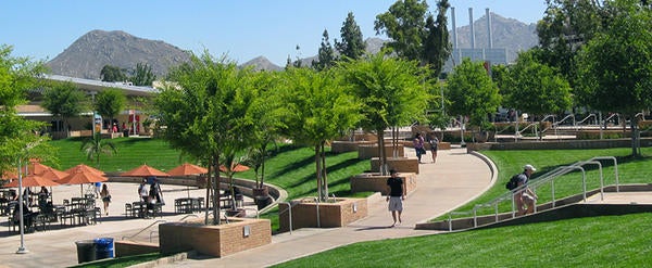 Lush green lawns surround the Highlander Union Building (HUB) on the UCR campus